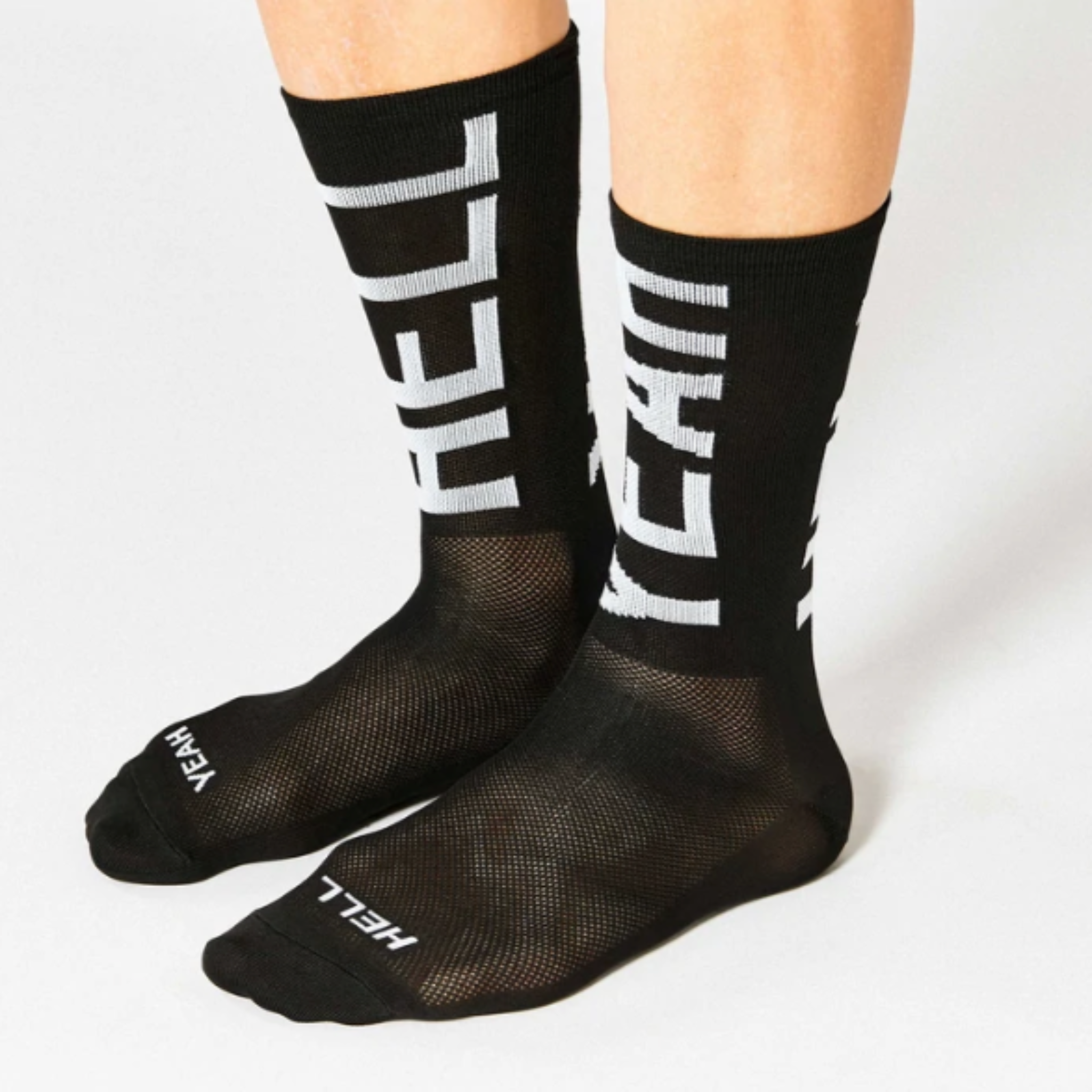 Cykelstrømpe i sort med hvid skrift, Hell Yeah. modellen hedder #666 hell yeah 2.0 og er fra Fingers Crossed